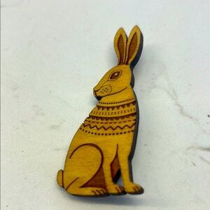 Charming wood pin featuring a hare, designed in a Scandinavian folk art style.